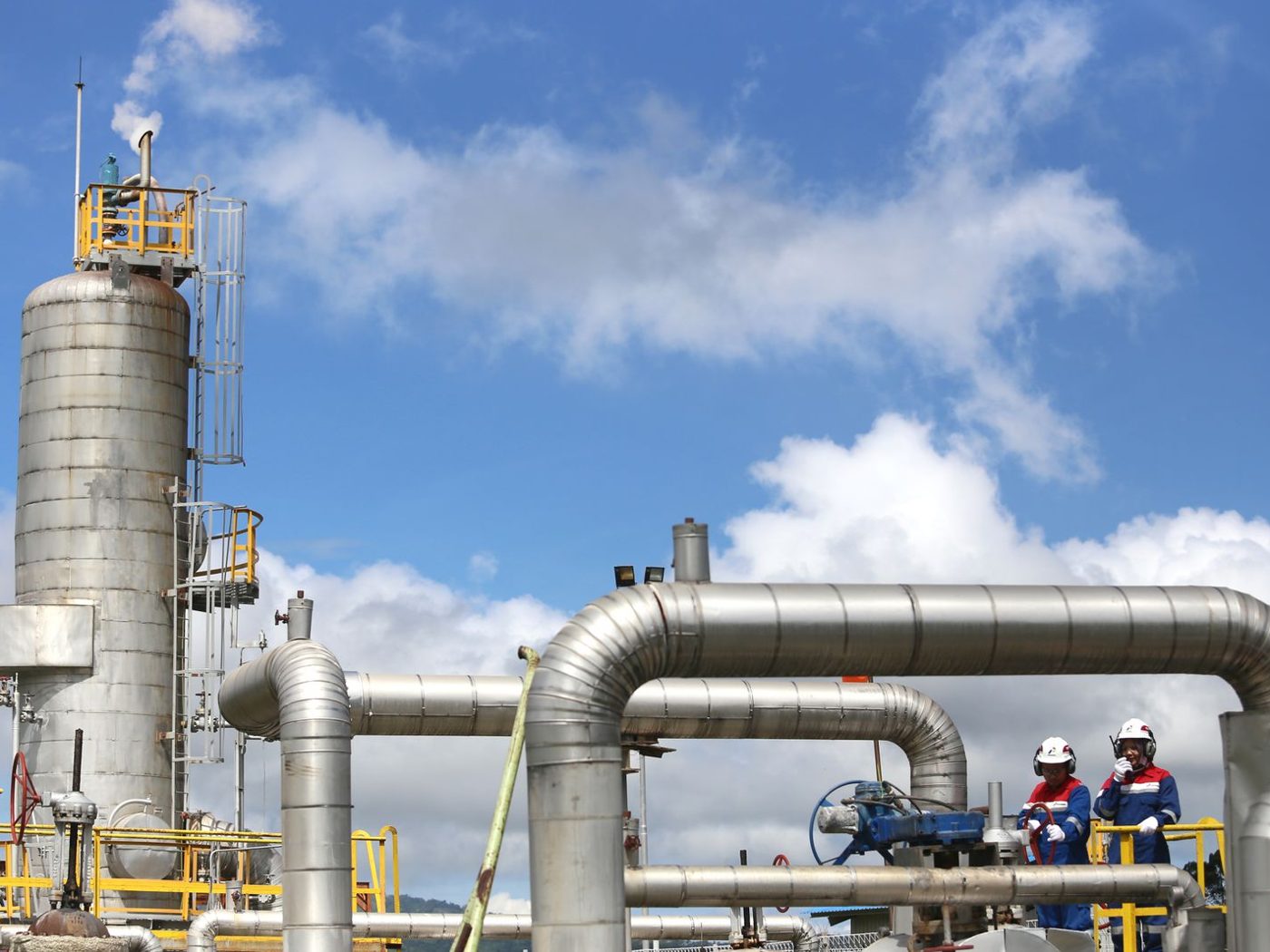 Engineers walking through a gas plant